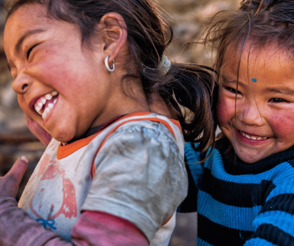 Two young girls laughing, capturing the warmth and hospitality of Mustang’s local communities. A reminder that the journey is as much about the people as the landscapes.