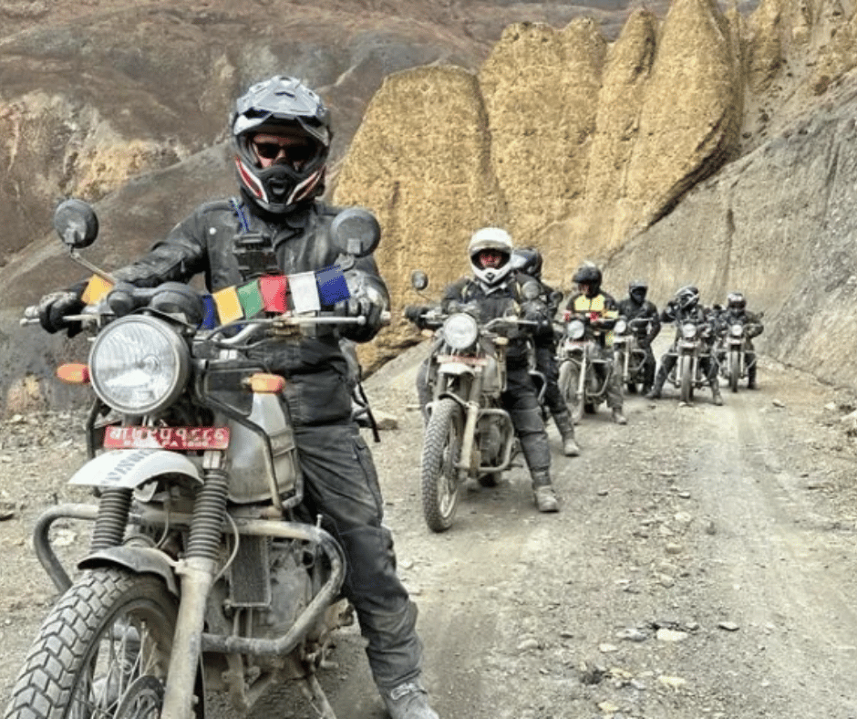 Riding through a dramatic canyon, with steep rock formations lining the trail—a perfect depiction of the challenging and rewarding Himalayan terrain.