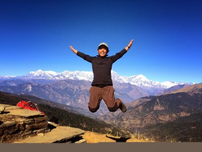 a man flying through the air on a mountain